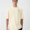 La t-shirt carota T-shirt con logo e toppa a forma di carota La t-shirt carota T-shirt con logo e toppa a forma di carota